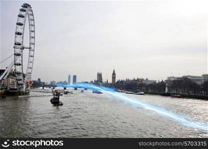 Blue streak of light passing over river Thames