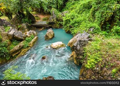 blue stream river / blue water pond in the jungle tropical forest