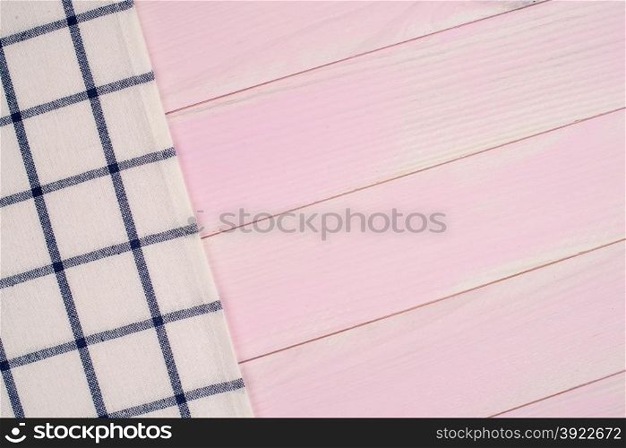 Blue striped towel over the surface of a wooden table.