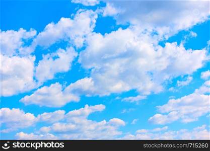 Blue summer sky with white cumulus clouds, may be used as background