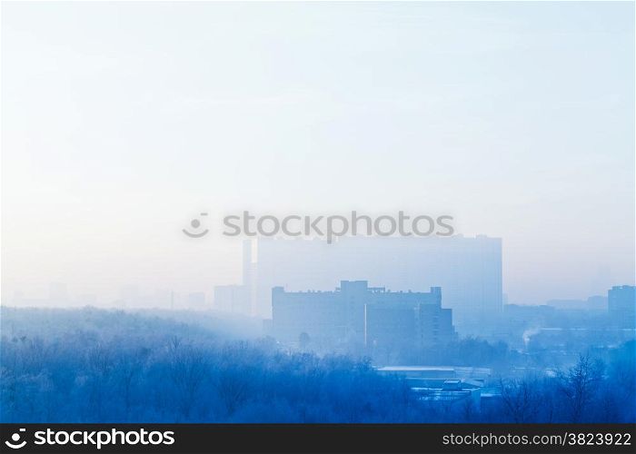 blue sunrise sky over city in cold winter morning