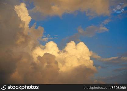 Blue sunset sky golden cumulus clouds background