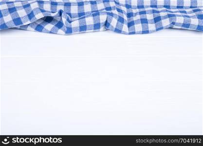 Blue table cloth on wooden background