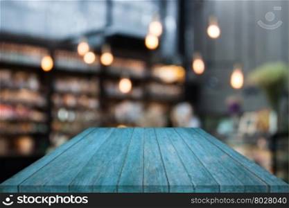 Blue table top wood with coffee shop blurred background with bokeh