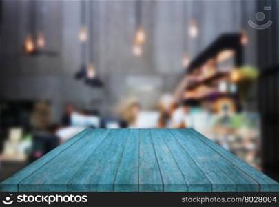 Blue table top wooden with blurred background in coffee shop, stock photo