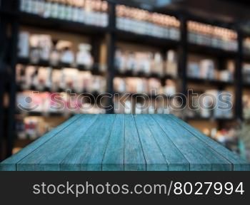 Blue tabletop wooden with blurred cafe background. product display template