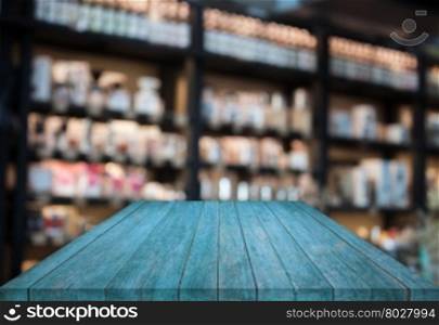 Blue tabletop wooden with blurred cafe background. product display template