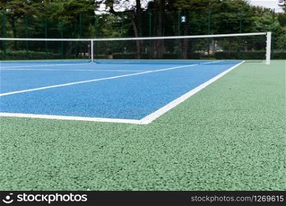 Blue Tennis court. Outdoor sunny day. Tennis concept. Copy space