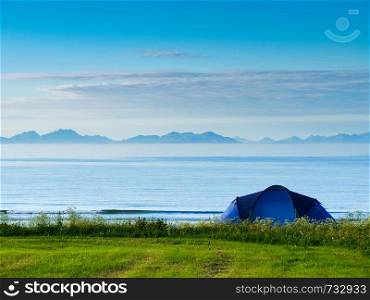 Blue tent on Gimsoysand sandy beach in summer. Camping on ocean shore. Lofoten archipelago Norway. Holidays and travel.. Tent on beach, Lofoten islands, Norway