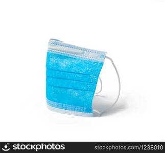 blue textile medical face mask with elastic bands folded, subject isolated on white background, element for designer