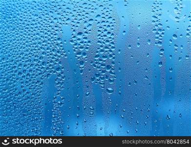 Blue texture with water drops on glass