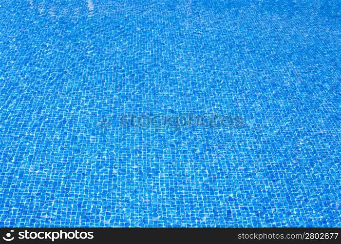 blue tiles pool water texture on clear summer sunny day