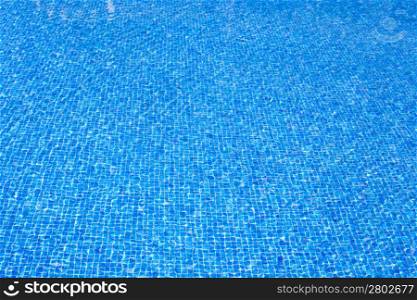 blue tiles pool water texture on clear summer sunny day