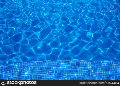 Blue tiles swimming pool water texture background