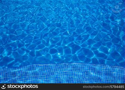 Blue tiles swimming pool water texture background