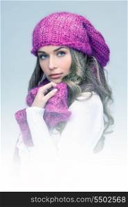 blue-toned picture of beautiful woman in winter hat