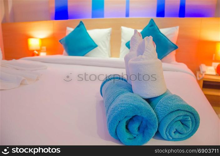 Blue towel on the bed at a luxury hotel.