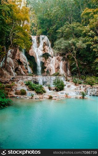 Blue turquoise water pond Kuang Si waterfall among rain forest in Luang Prabang, Laos during summer season.