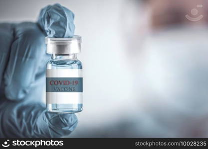 Blue vaccine jar bottle for treatment from corona virus infection and build immunity to viruses Covid-19 , Healthcare And Medical concept.