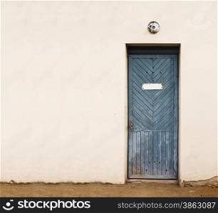 blue vintage door with empty white doorplate