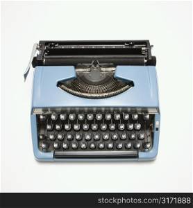 Blue vintage typewriter on white background.