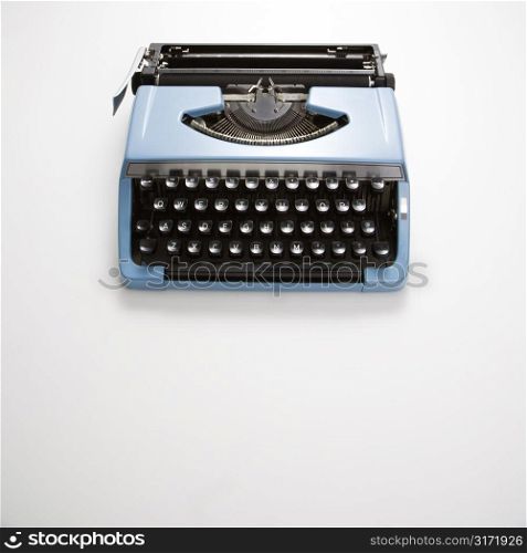 Blue vintage typewriter on white background.