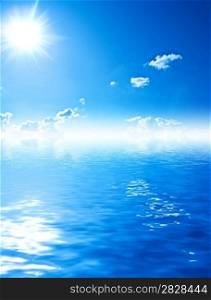blue water and sky with sun