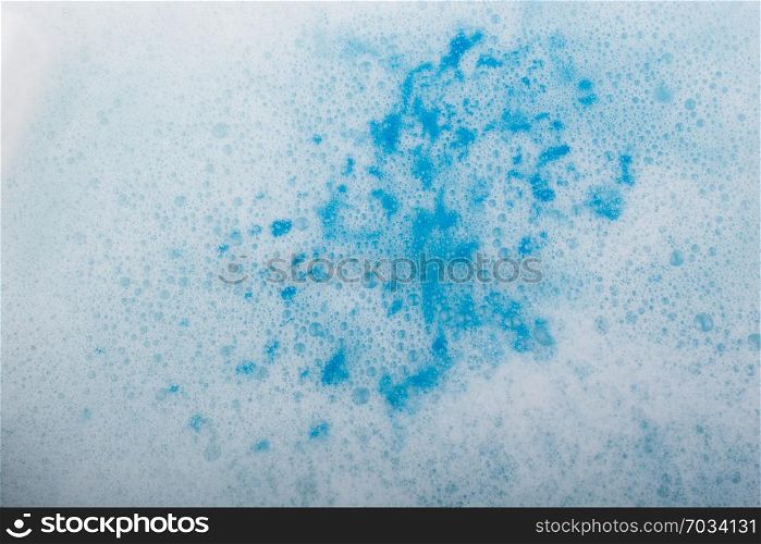 Blue water covered with foam and bubles