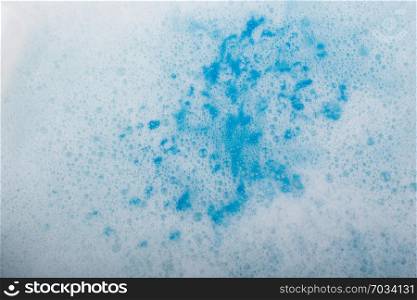 Blue water covered with foam and bubles