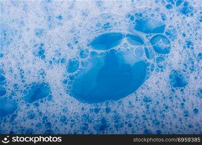 Blue water covered with foam and bubles of shampoo. Blue water covered with foam and bubles