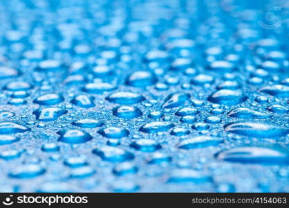 blue water drops on glass, shallow dof