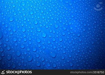 blue water drops on glass, top view