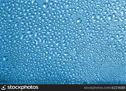 blue water drops over brushed metal background