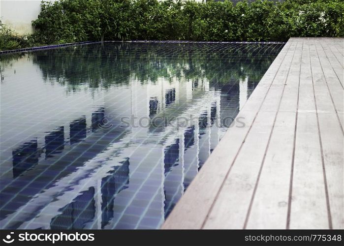 Blue water swimming pool with day light, stock photo