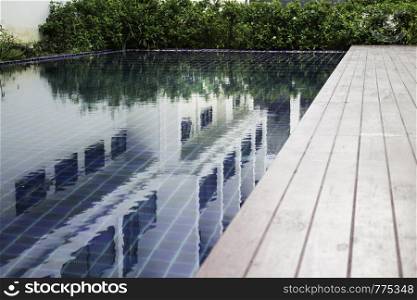 Blue water swimming pool with day light, stock photo