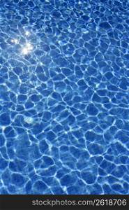 Blue water texture, tiles pool in sunny day with light reflections