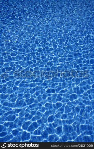 Blue water texture, tiles pool in sunny day with light reflections