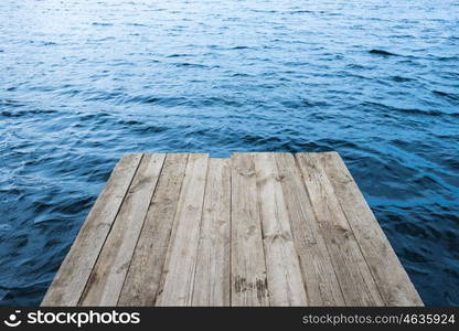 Blue water with empty wooden platform. Natural background