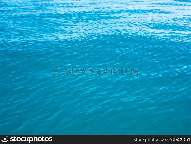Blue water with sun reflections
