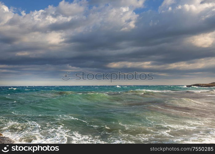 Blue wave on the beach. Blur background and sunlight spots. Dramatic natural background.