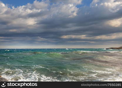 Blue wave on the beach. Blur background and sunlight spots. Dramatic natural background.