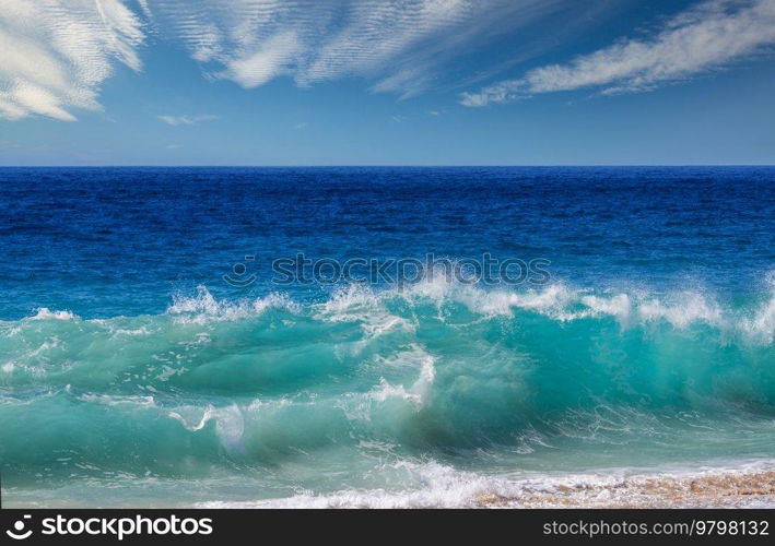 Blue wave on the beach. Dramatic natural background.