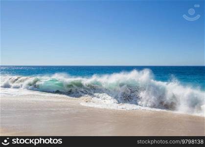 Blue wave on the beach. Dramatic natural background.