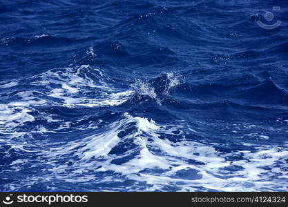 Blue wawy water with white foam in storme sea ocean surface