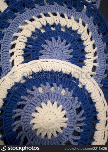 Blue, white round crochet elements and balls of yarn. Crochet texture, place for an inscription, adapted for mobile. Blue, white round crochet elements and balls of yarn. Crochet texture, place for an inscription, adapted for mobile phone