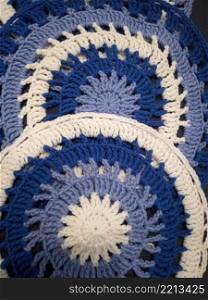 Blue, white round crochet elements and balls of yarn. Crochet texture, place for an inscription, adapted for mobile. Blue, white round crochet elements and balls of yarn. Crochet texture, place for an inscription, adapted for mobile phone