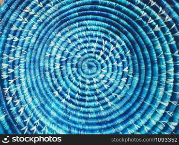 Blue wicker round dish. Clouse up image. Beautiful colorful texture. Wallpaper, banner, background. Countryside, healthy life, natural, simplicity, organic concept
