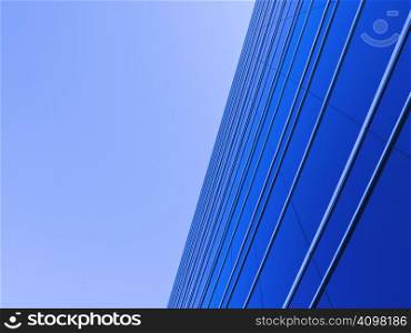 Blue windows reflecting the clear blue sky.