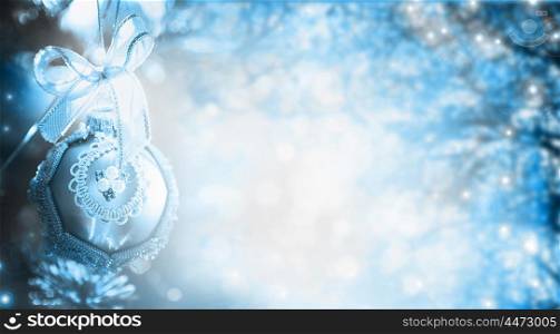 Blue Winter Christmas background with tree, branches and bauble, holiday border. Banner for website
