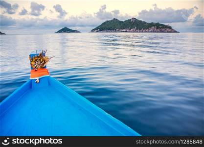 blue wood boat heading to destination island